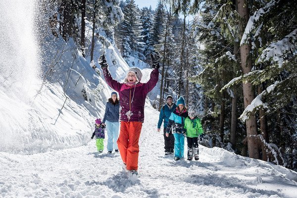 Family hiking in a snowy mountain area