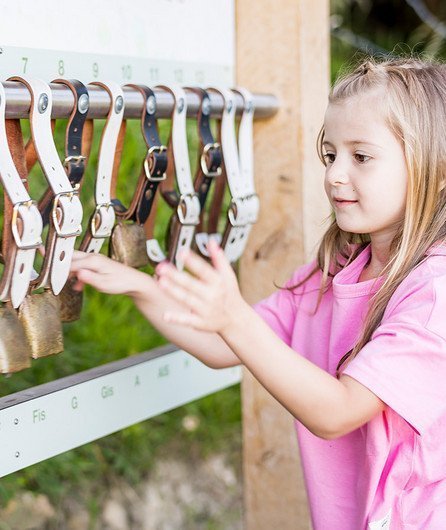 girl plays with bells